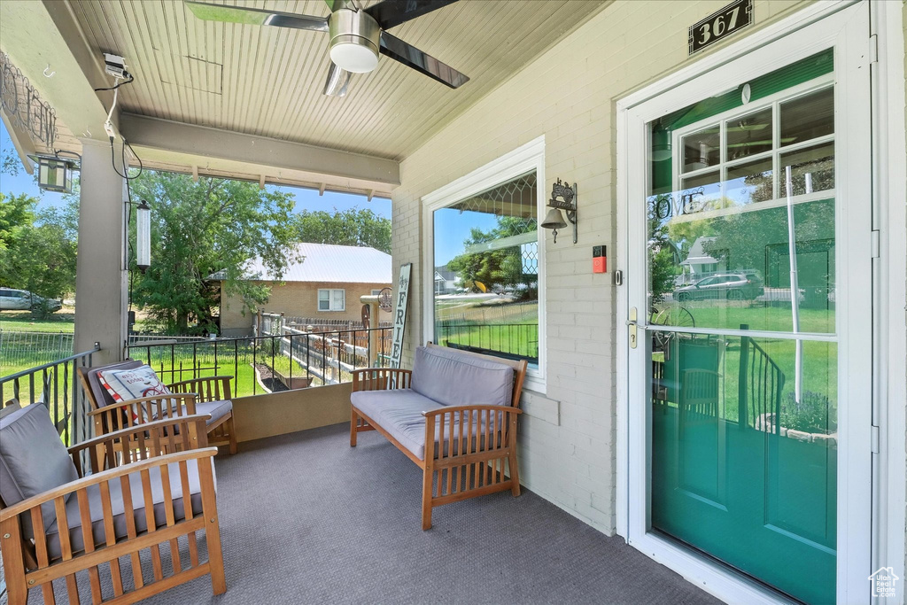 Covered porch featuring ceiling fan