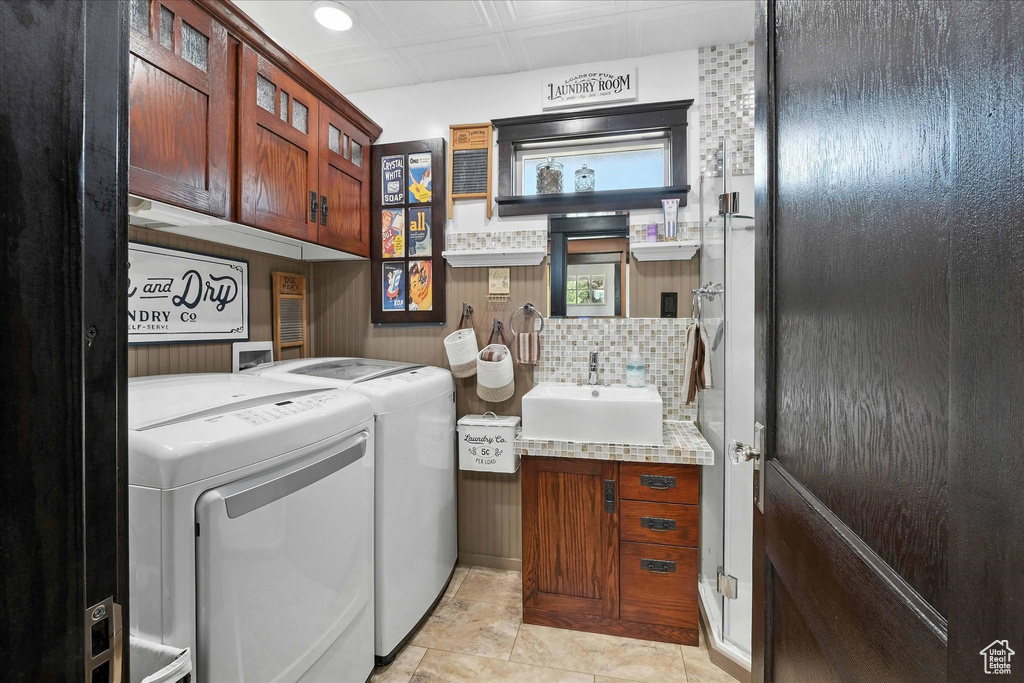 Washroom with washing machine and clothes dryer, cabinet space, and recessed lighting
