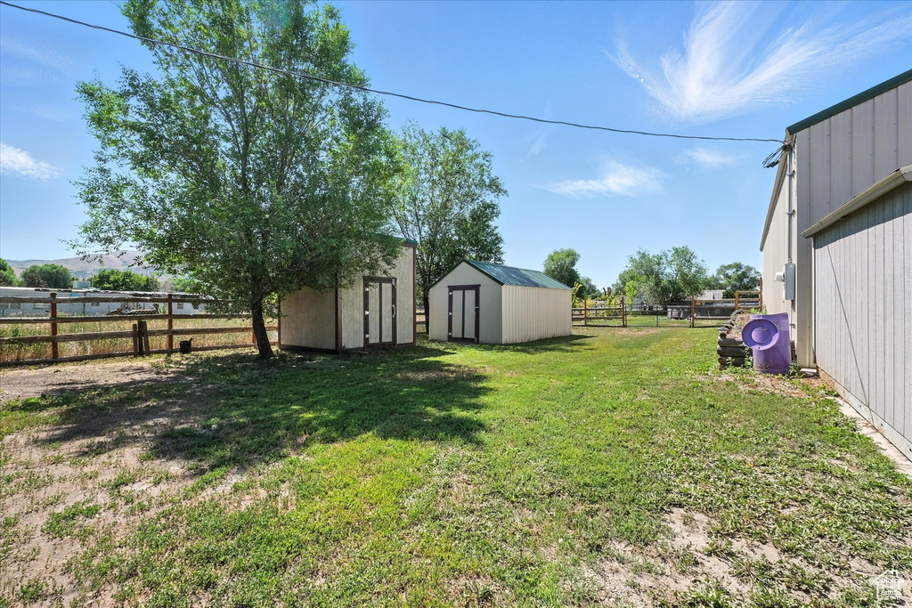 Fenced backyard with a storage shed