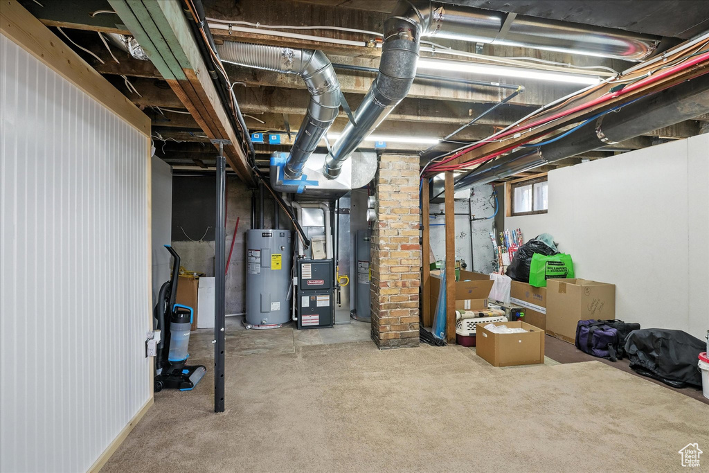 Below grade area featuring electric water heater and heating unit