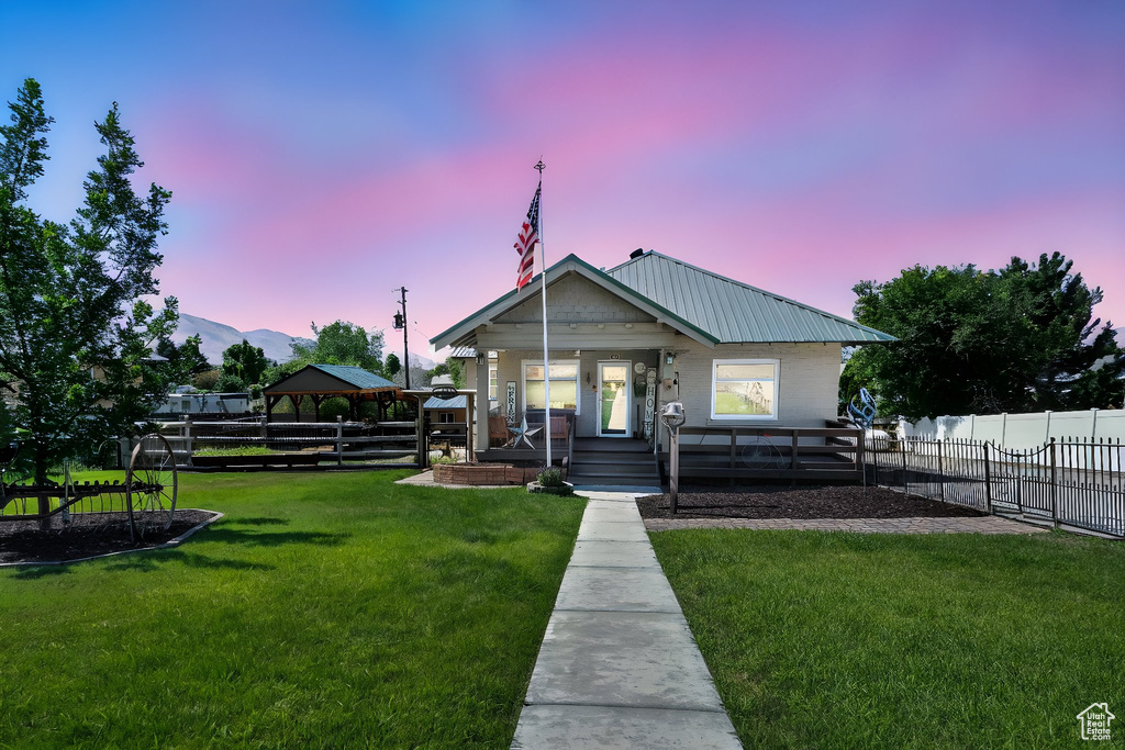 Bungalow-style house with covered porch, a gazebo, a metal roof, and a mountain view