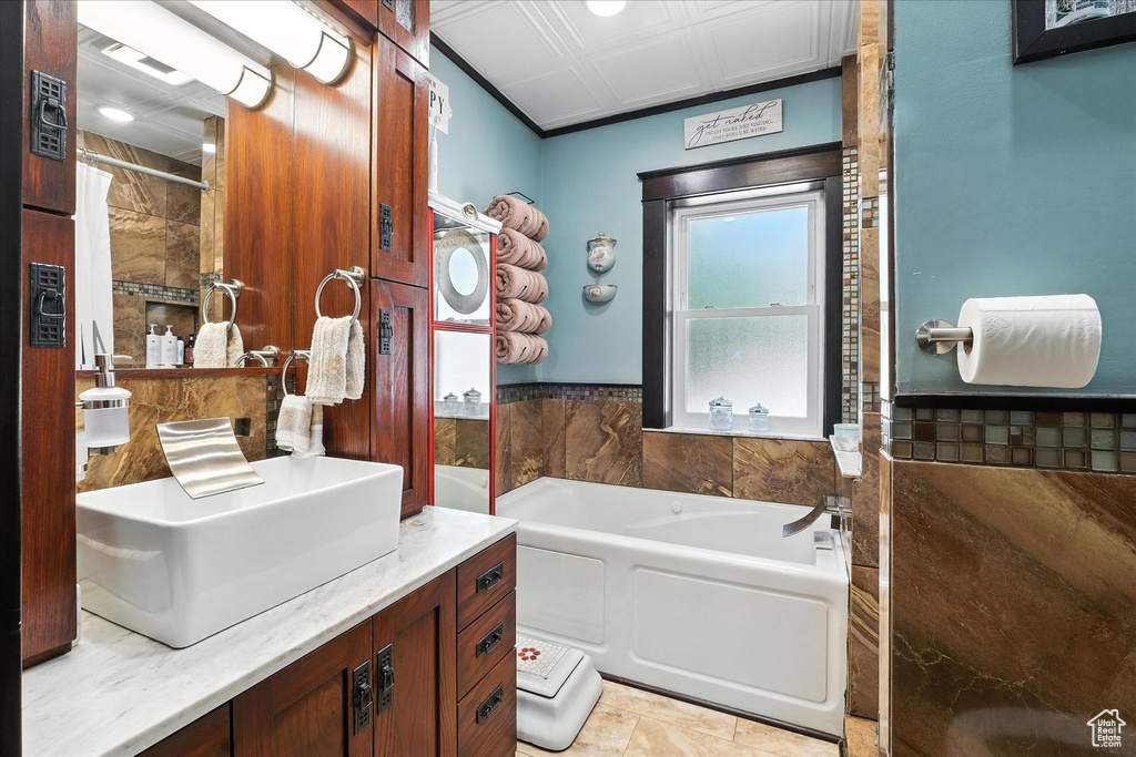 Bathroom featuring a bath, vanity, and a shower