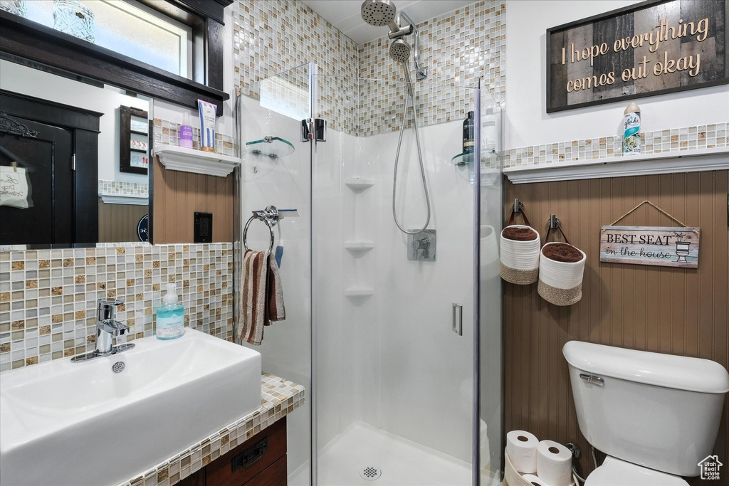 Full bath with backsplash, a shower stall, and vanity