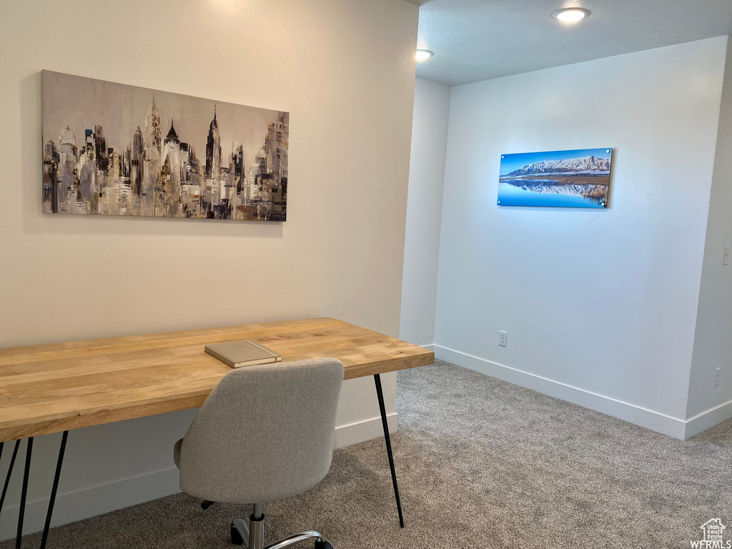 Carpeted home office with baseboards