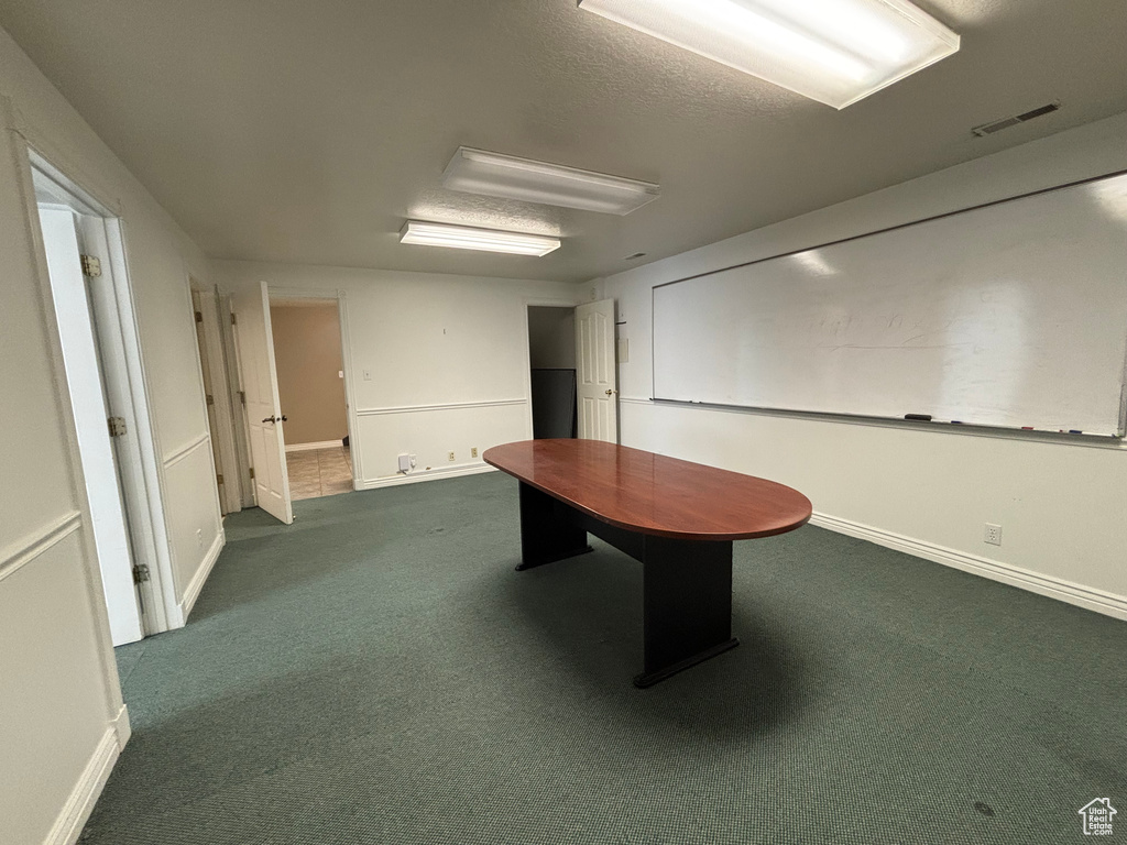 Recreation room with dark carpet and baseboards