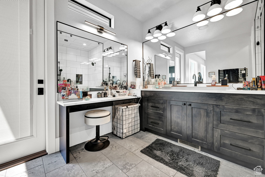 Bathroom featuring a shower stall and vanity