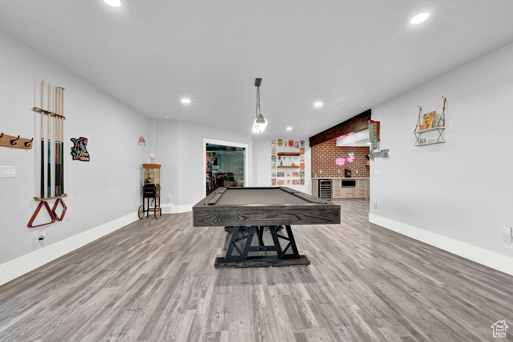 Recreation room with billiards table, recessed lighting, wood finished floors, a brick fireplace, and beverage cooler