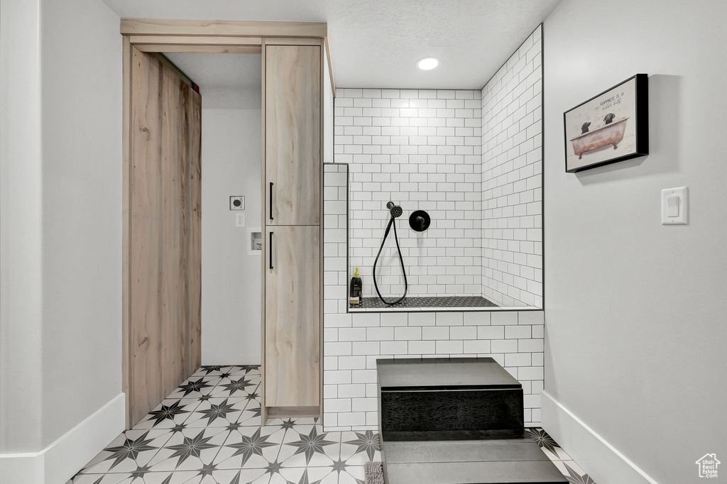Bathroom with walk in shower and baseboards