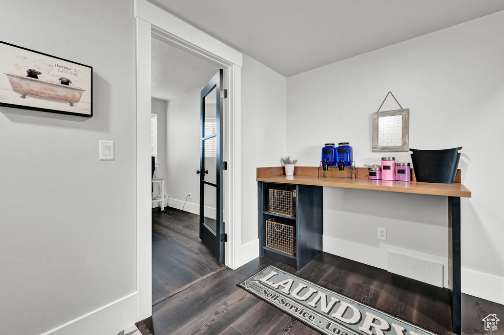 Office space featuring dark wood finished floors and baseboards
