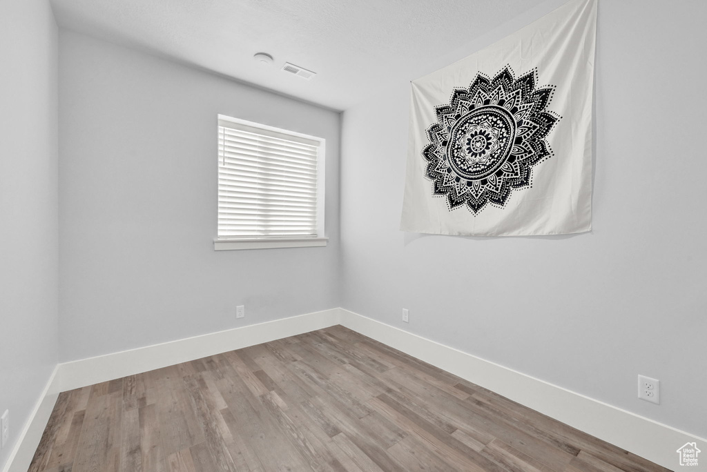 Spare room featuring wood finished floors