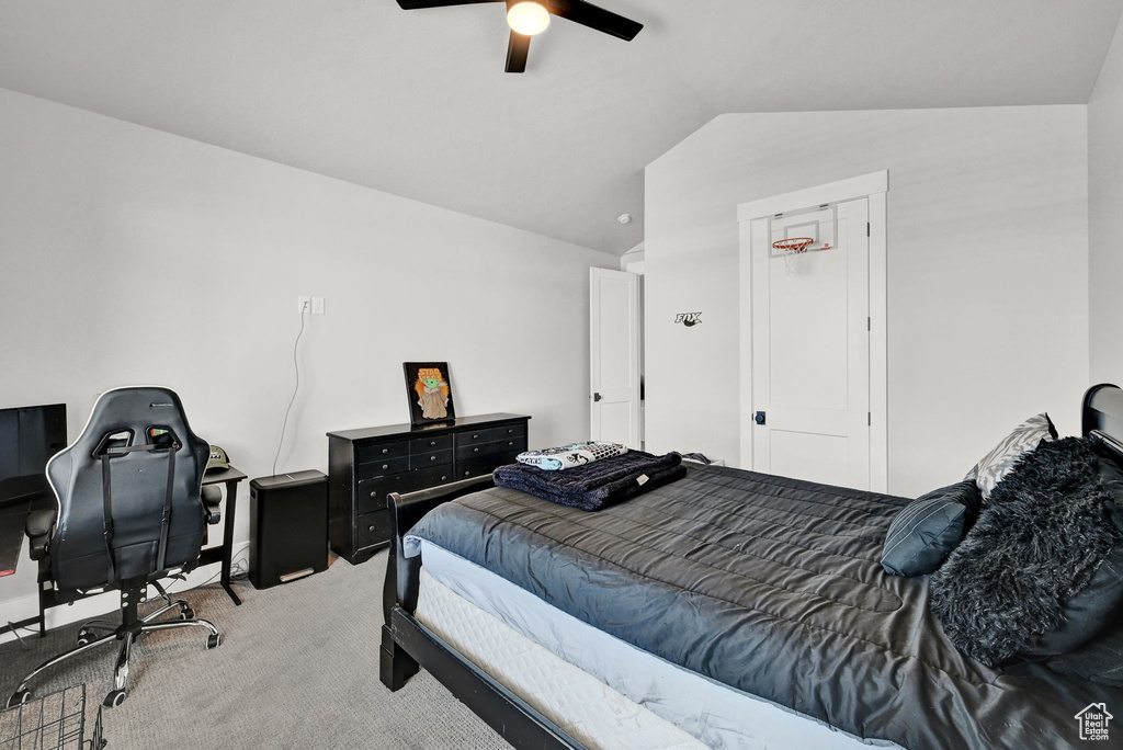 Bedroom with carpet floors, vaulted ceiling, and a ceiling fan