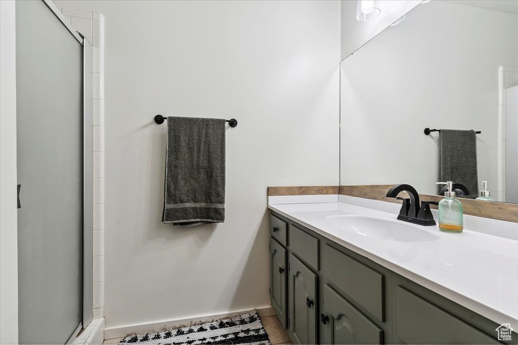 Full bath featuring vanity, a shower stall, and tile patterned floors