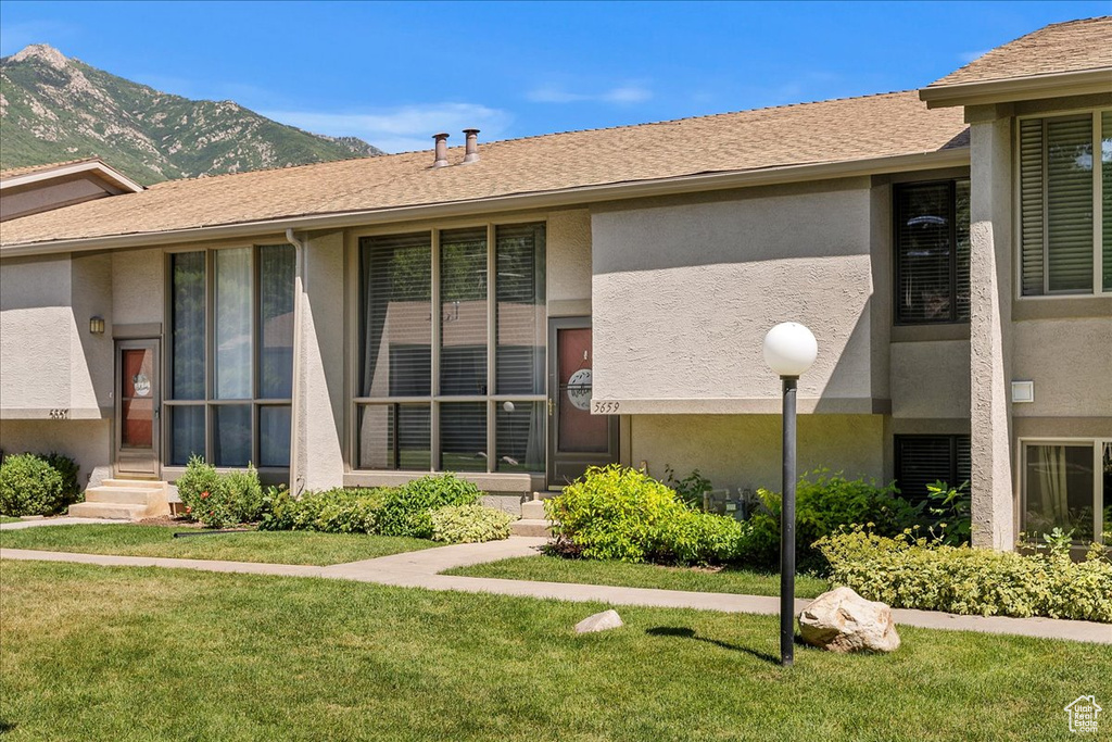 View of building exterior featuring a mountain view and entry steps