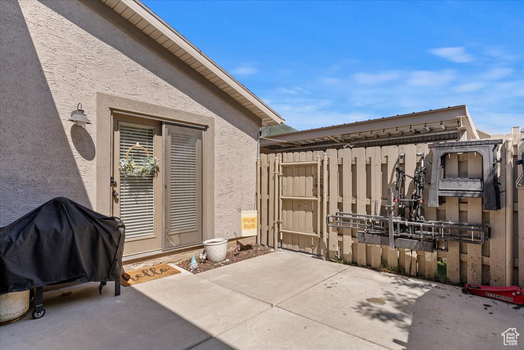 View of patio with a grill