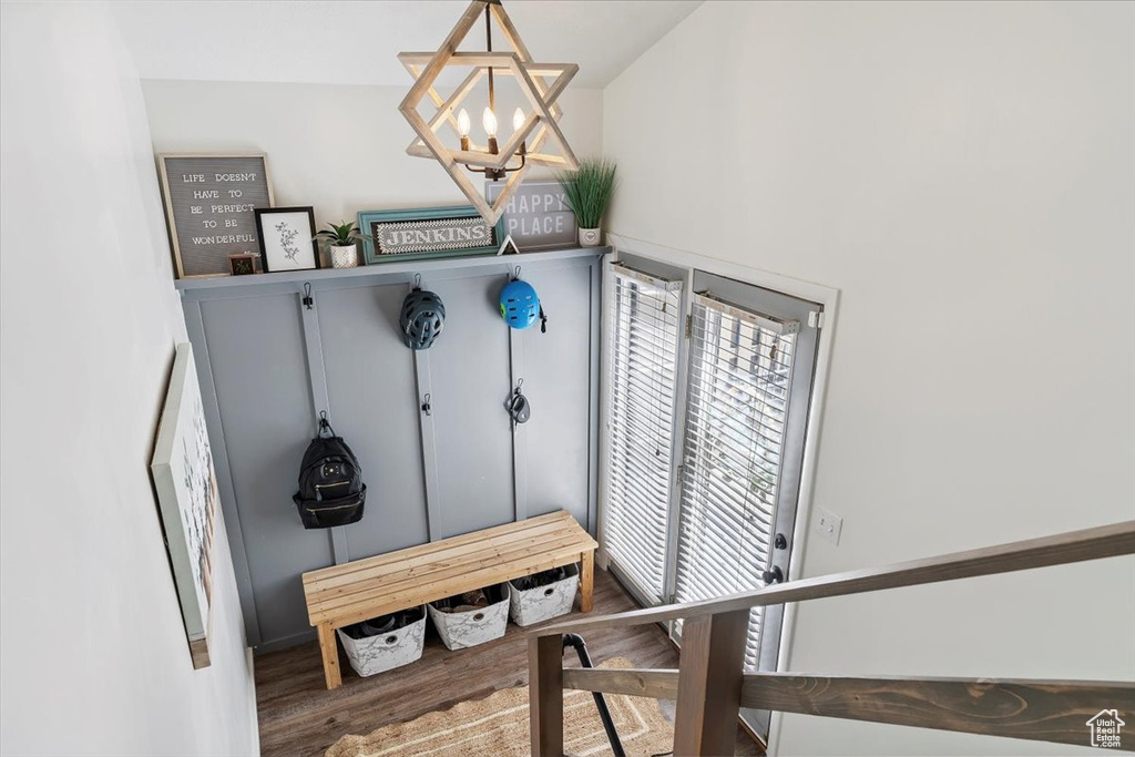 Mudroom featuring a chandelier and wood finished floors