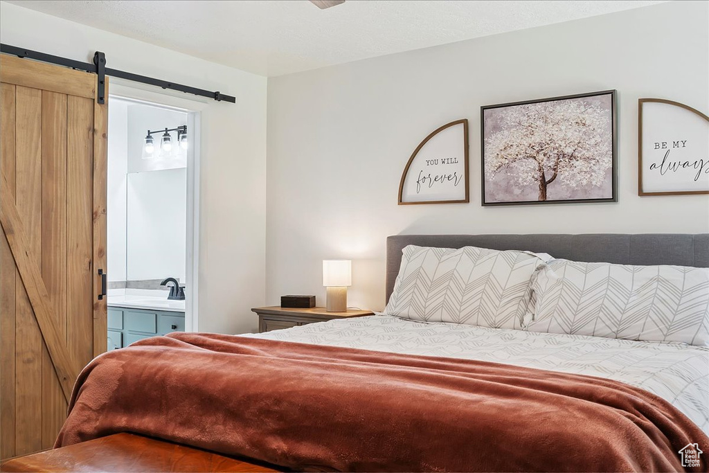 Bedroom with a barn door and ensuite bathroom