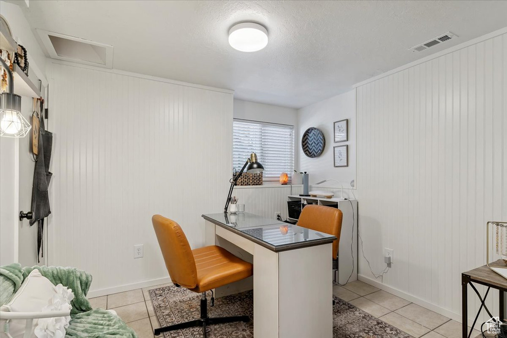 Office featuring light tile patterned flooring, attic access, and a textured ceiling