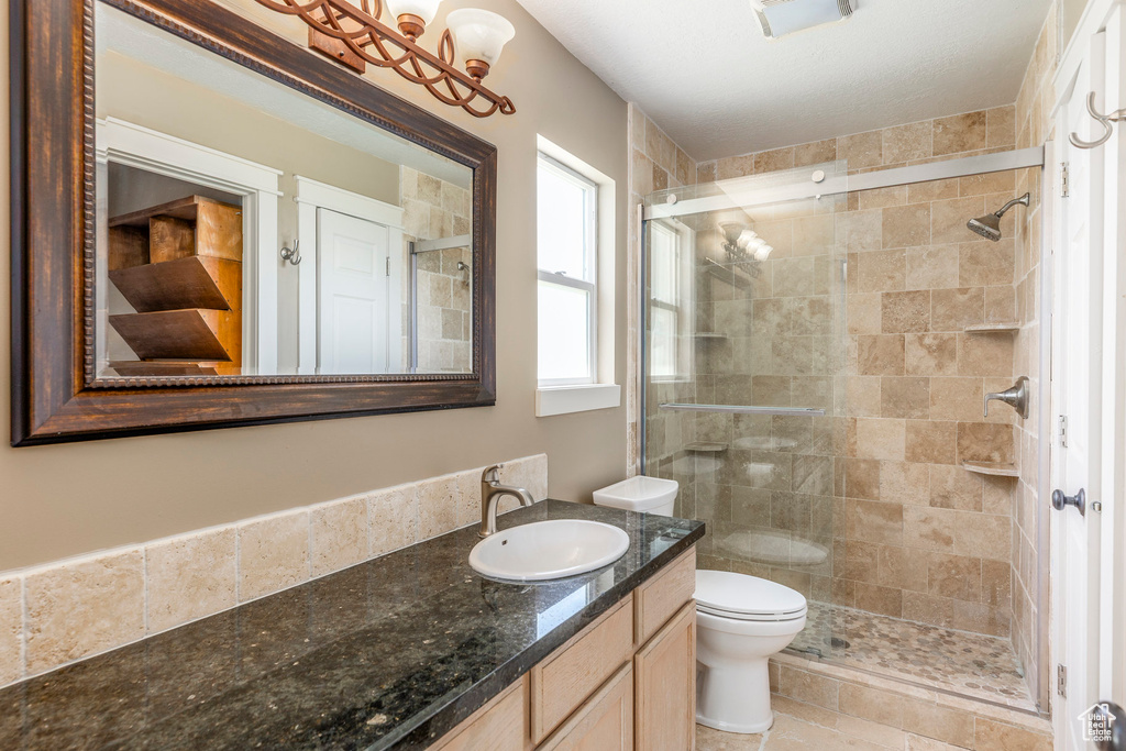 Full bath featuring vanity and a stall shower