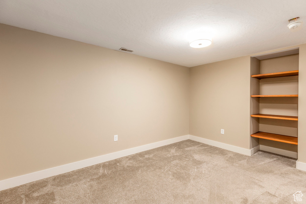 Unfurnished room with carpet flooring and a smoke detector