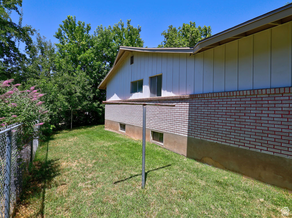 View of side of property with board and batten siding and brick siding