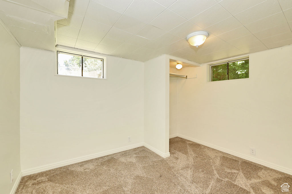 Below grade area featuring carpet floors and healthy amount of natural light