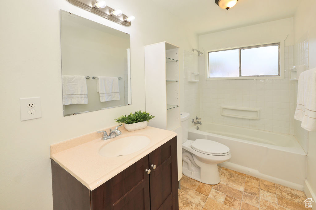 Full bath featuring vanity and bathing tub / shower combination
