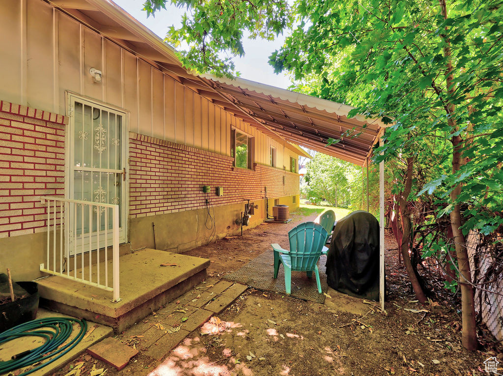 View of patio with a grill