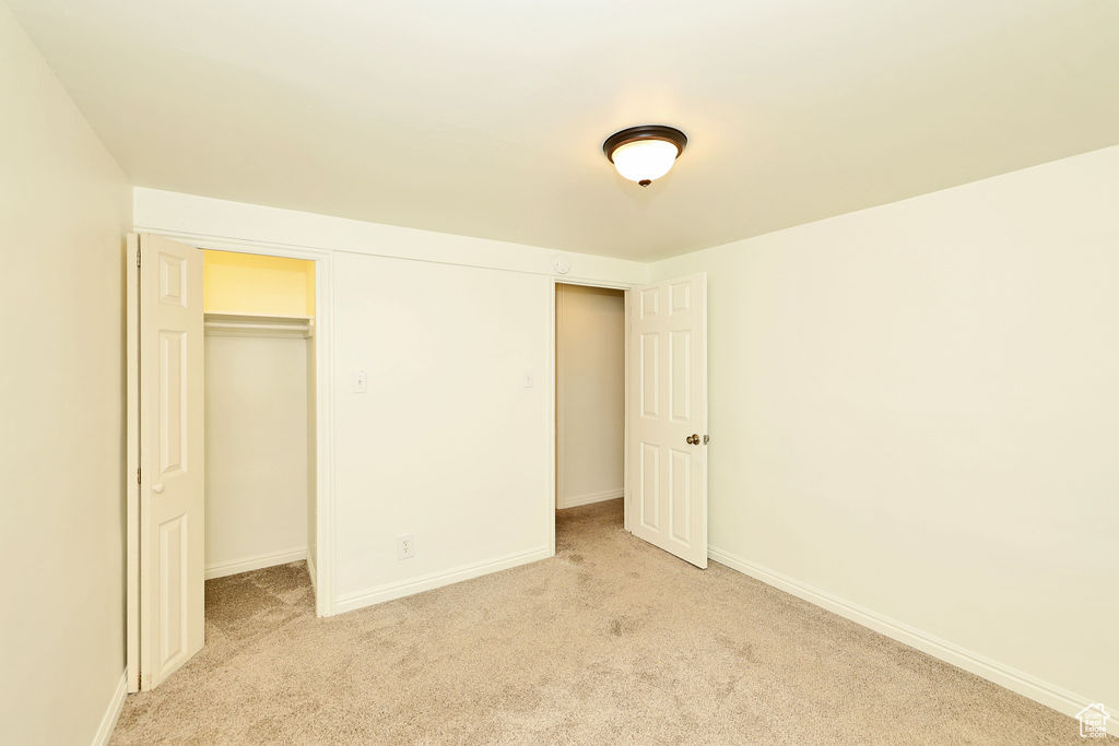 Unfurnished bedroom with light carpet