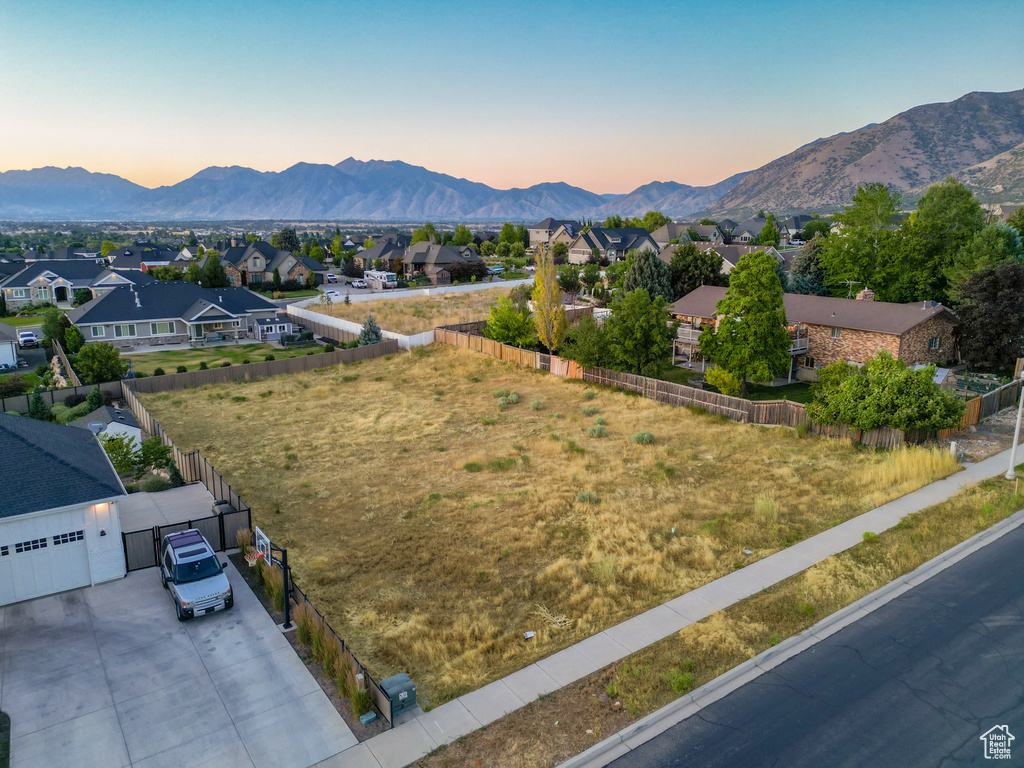 View of mountain backdrop featuring nearby suburban area