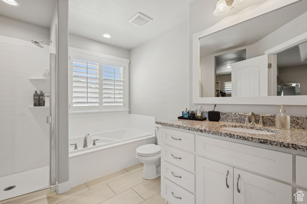 Full bathroom with vanity, a garden tub, a stall shower, and tile patterned floors