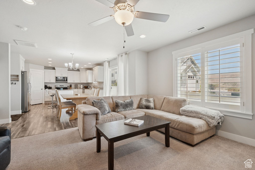 Living area featuring a chandelier, recessed lighting, and ceiling fan