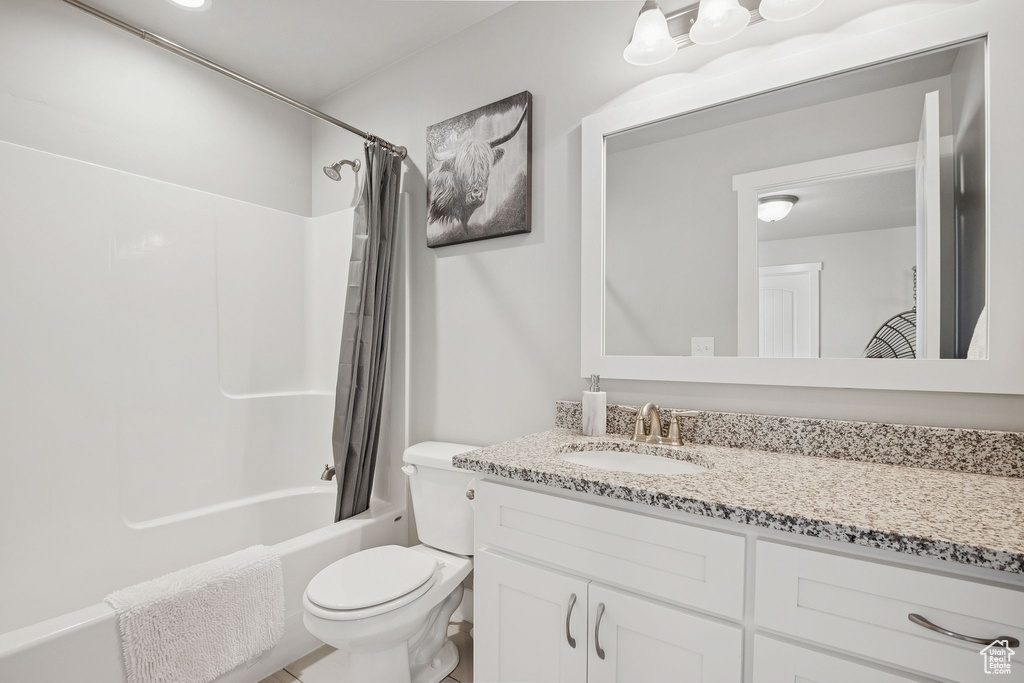 Full bath featuring vanity and shower / bathtub combination with curtain