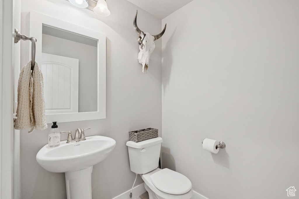 Bathroom with toilet and baseboards