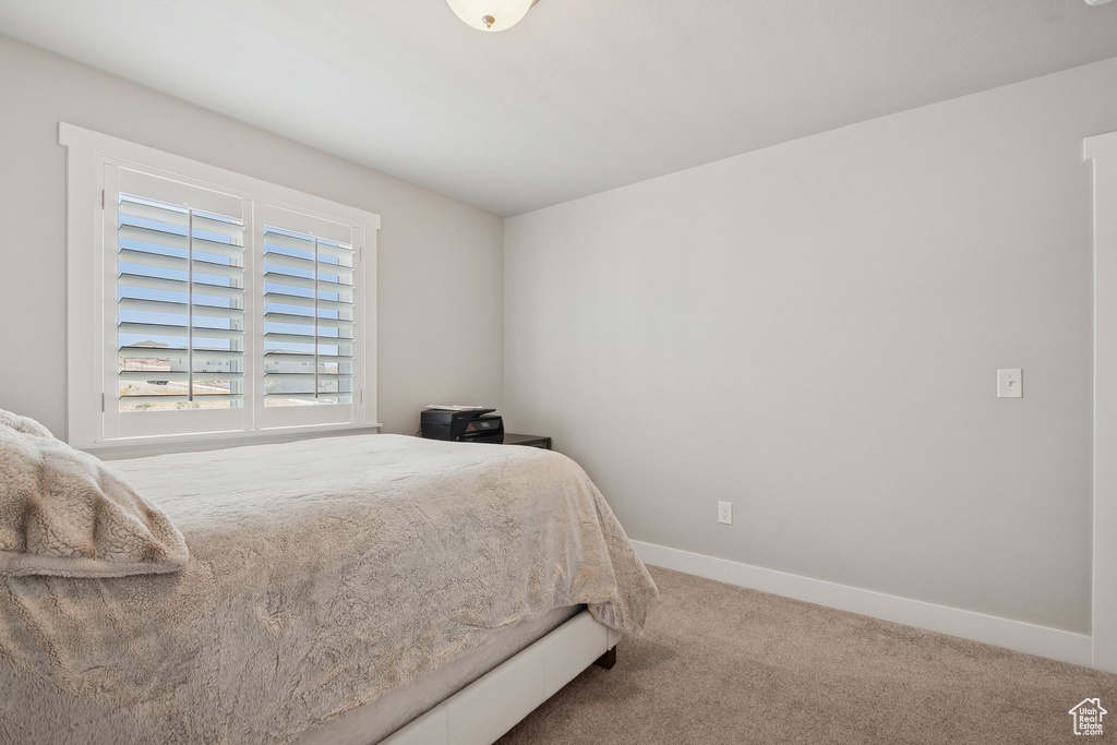 Carpeted bedroom with baseboards