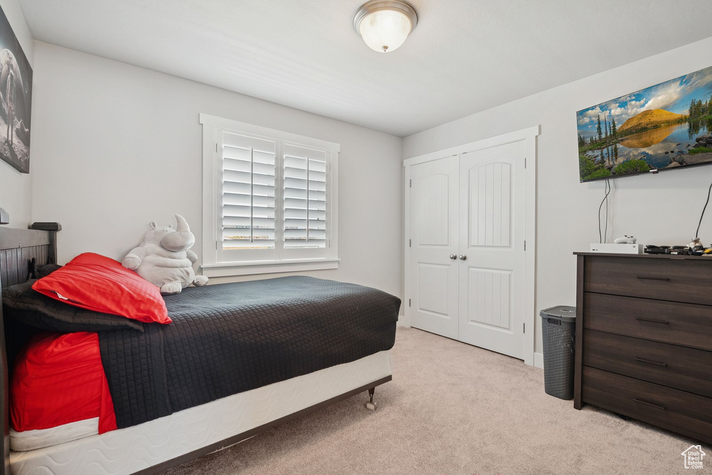 Carpeted bedroom with a closet