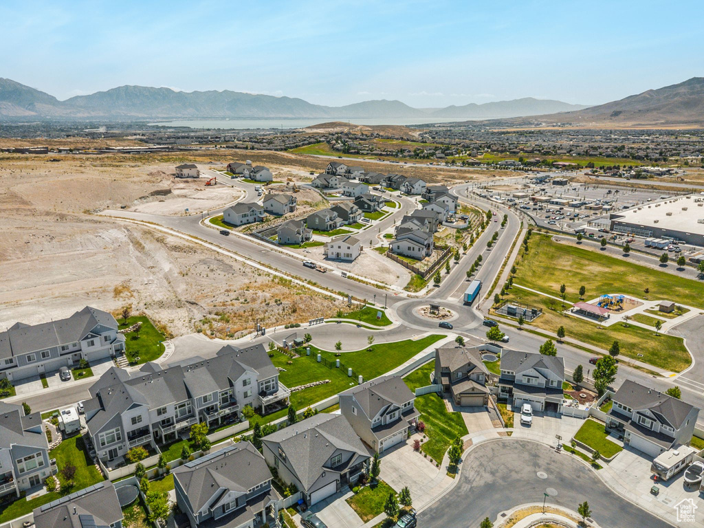 Aerial overview of property's location with a mountain backdrop and nearby suburban area