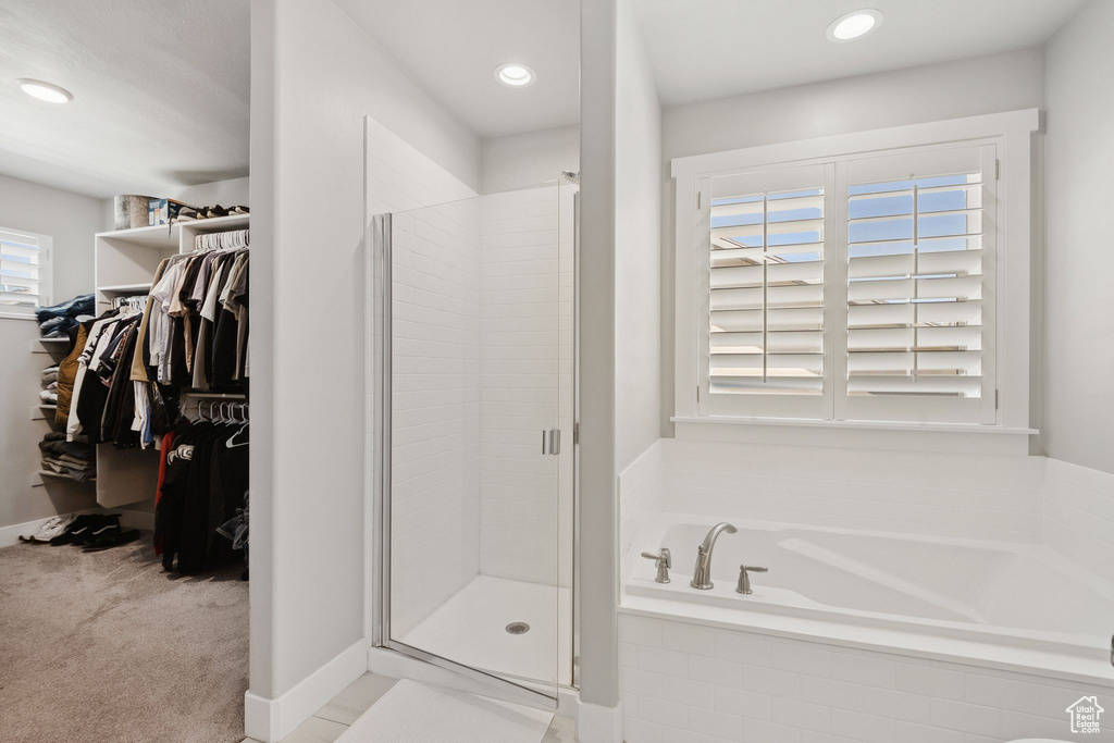 Full bath with a bath, a stall shower, a walk in closet, and recessed lighting