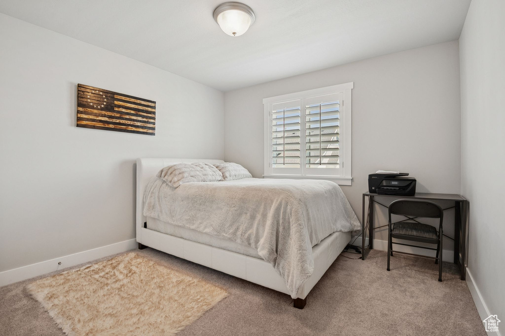 Carpeted bedroom with baseboards