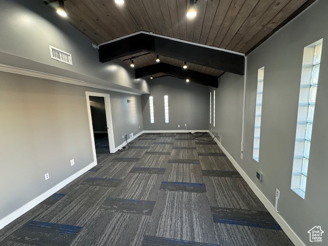 Carpeted spare room featuring a wooden ceiling with exposed beams and track lighting