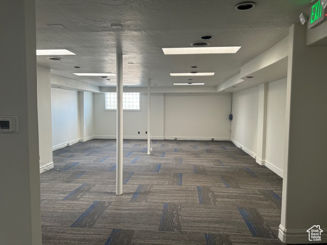 Below grade area featuring carpet flooring and baseboards