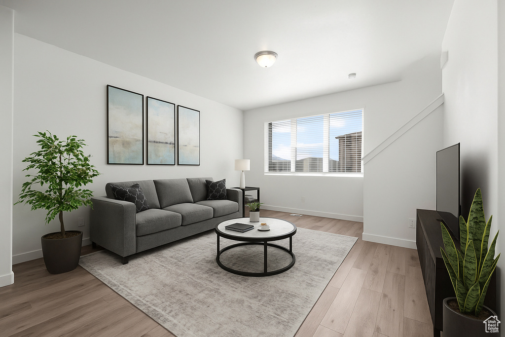 Living area featuring light wood finished floors and baseboards