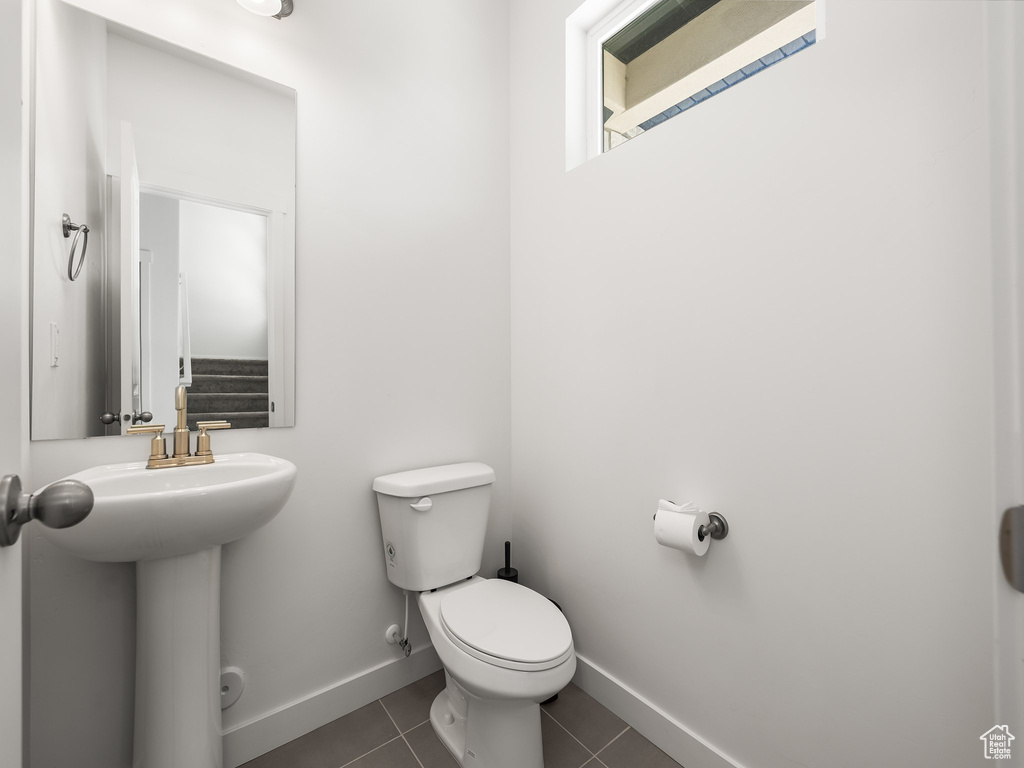 Bathroom with tile patterned floors and toilet