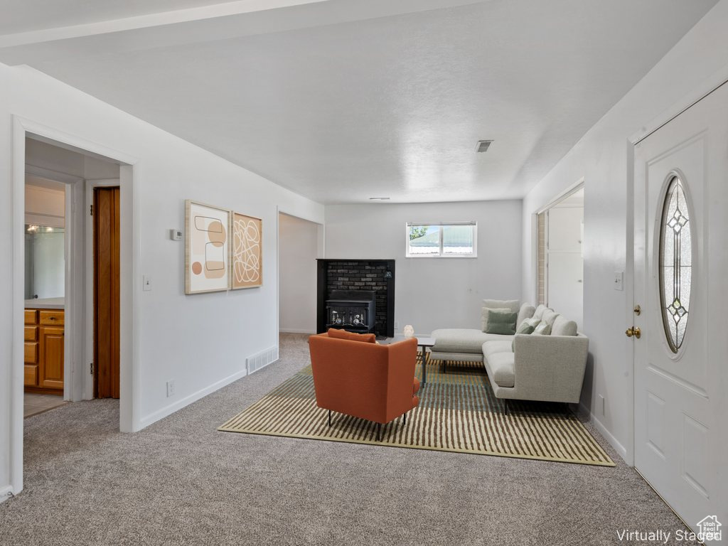 Living room with carpet floors and a brick fireplace