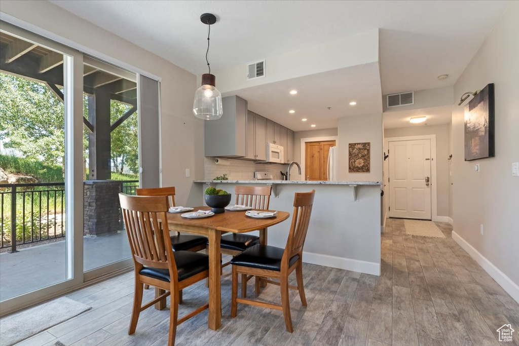Dining space featuring light wood-style flooring and recessed lighting