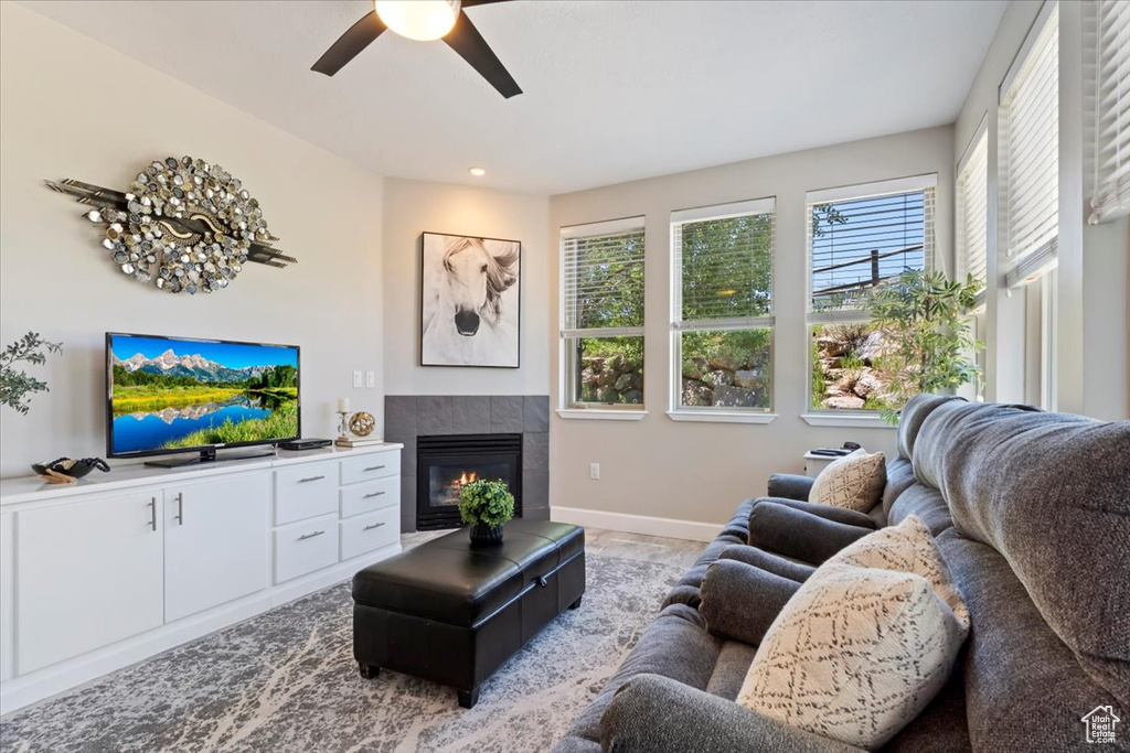 Living area with a ceiling fan, a fireplace, and recessed lighting