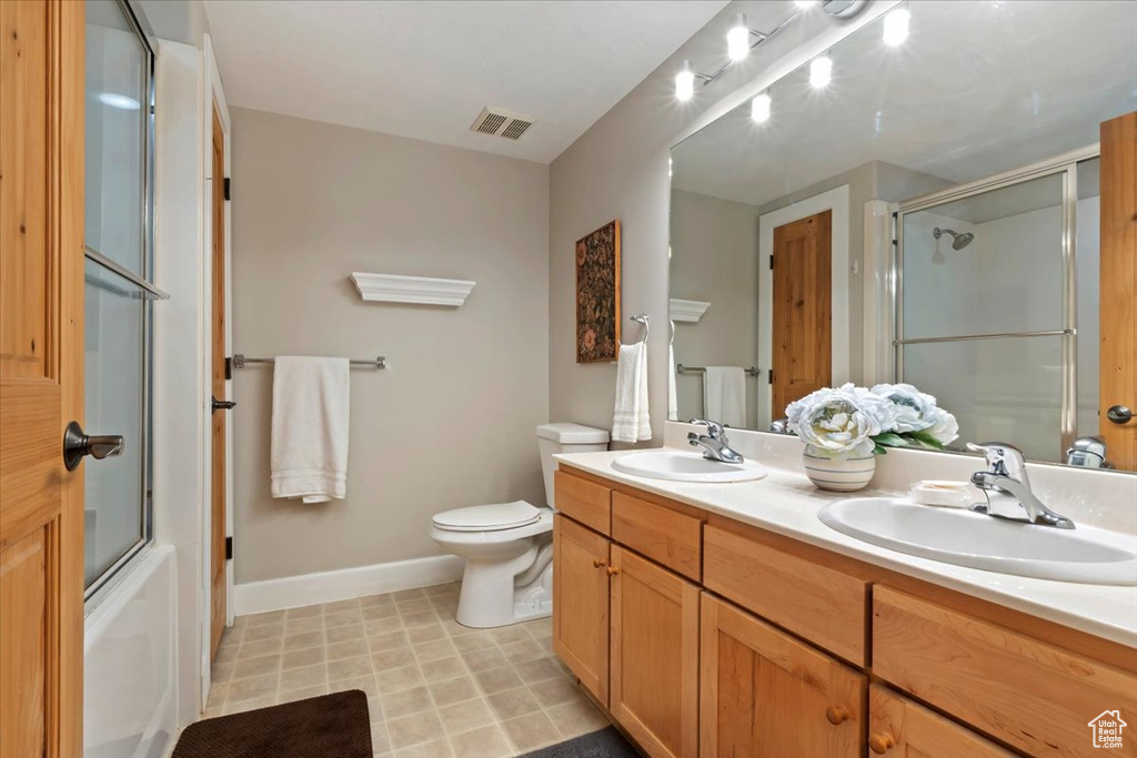 Bathroom featuring double vanity and baseboards