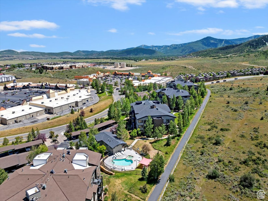Drone / aerial view of a mountain backdrop and a pool