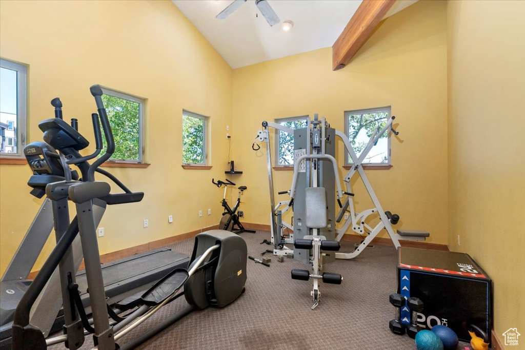 Workout area with lofted ceiling and baseboards