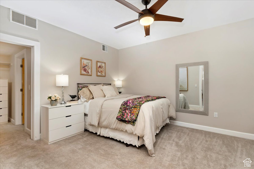 Bedroom featuring light carpet and ceiling fan