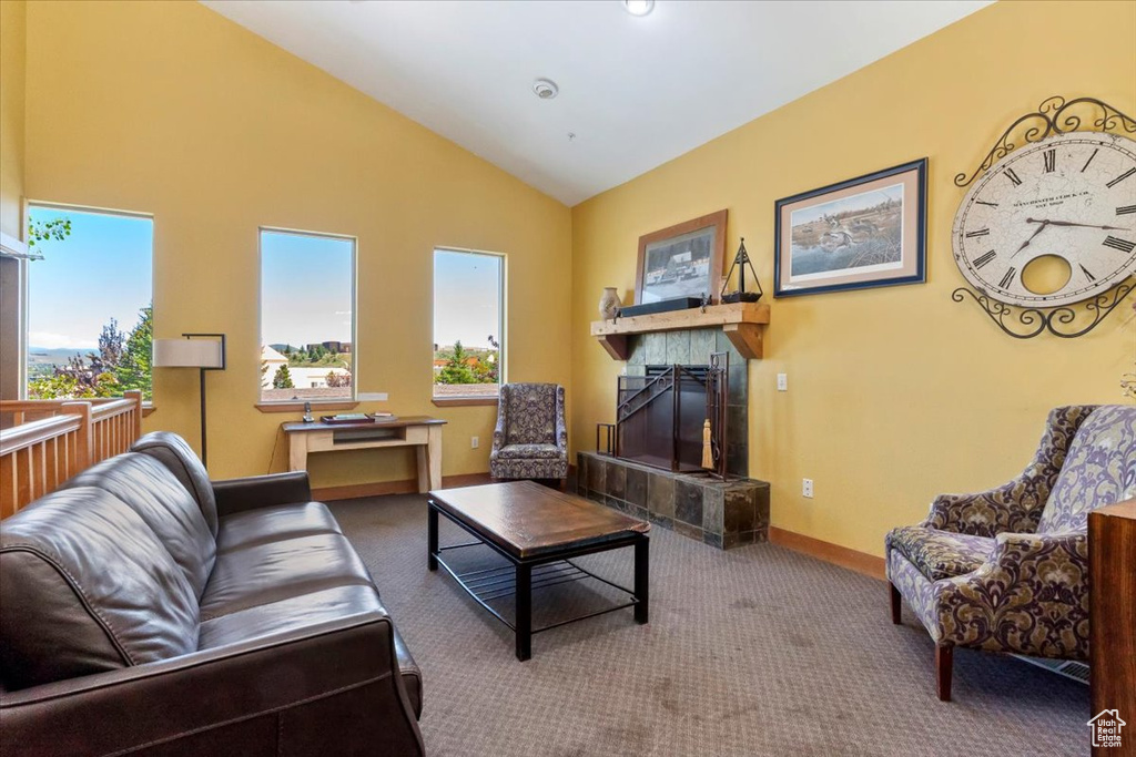 Carpeted living room featuring a fireplace and lofted ceiling